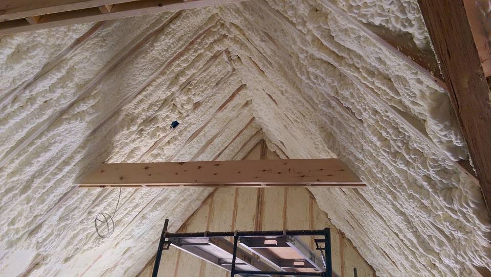 Thick open-cell spray foam insulation applied to the rafters and ridge of a Maine attic