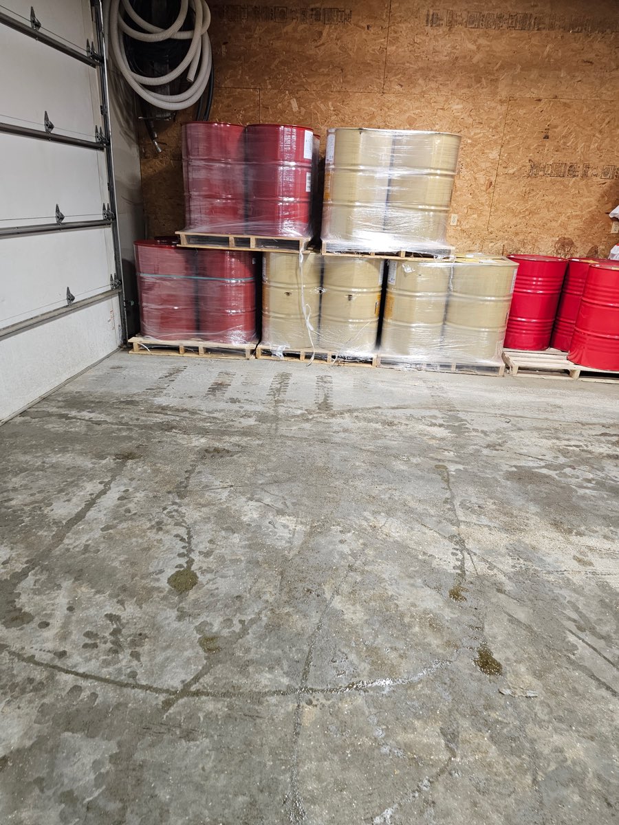 Drums of A-side and B-side spray foam material on pallets in the Maine-ly Foam shop