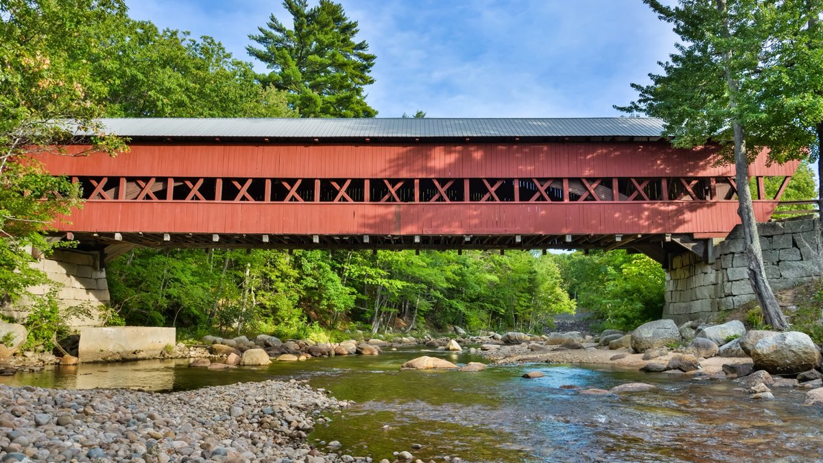The red Swift River covered bridge crossing the Swift River in Conway, New Hampshire